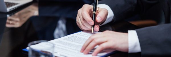 businessman-signing-the-papers